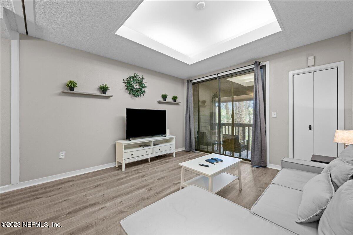 3155 Ravines Road, Unit 3522 Middleburg, FL 32068 - Photo 3 of 20 a living room with furniture and a flat screen tv