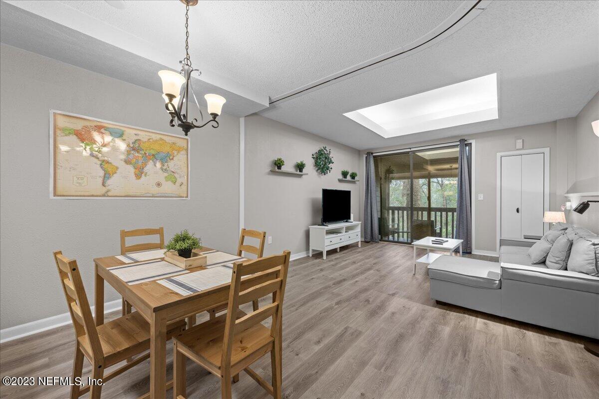 3155 Ravines Road, Unit 3522 Middleburg, FL 32068 - Photo 6 of 20 a view of a livingroom and dining room with furniture wooden floor a chandelier
