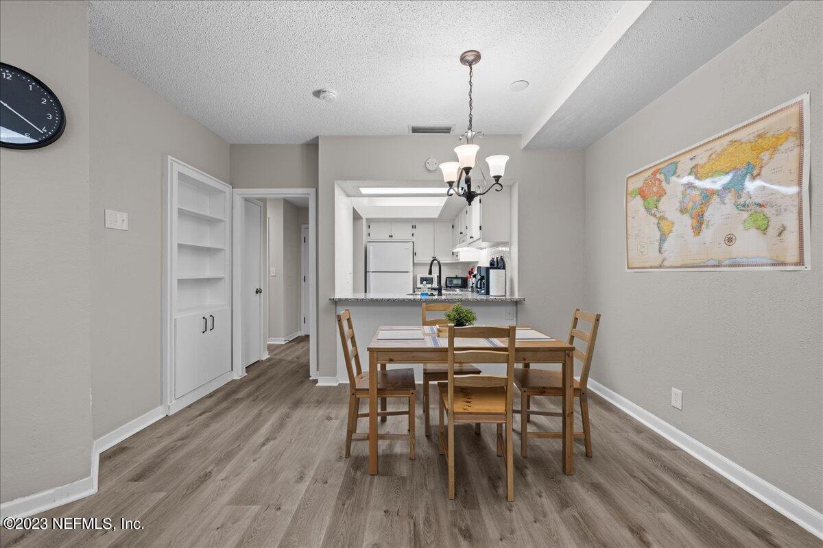 3155 Ravines Road, Unit 3522 Middleburg, FL 32068 - Photo 7 of 20 a view of a dining room with furniture and wooden floor