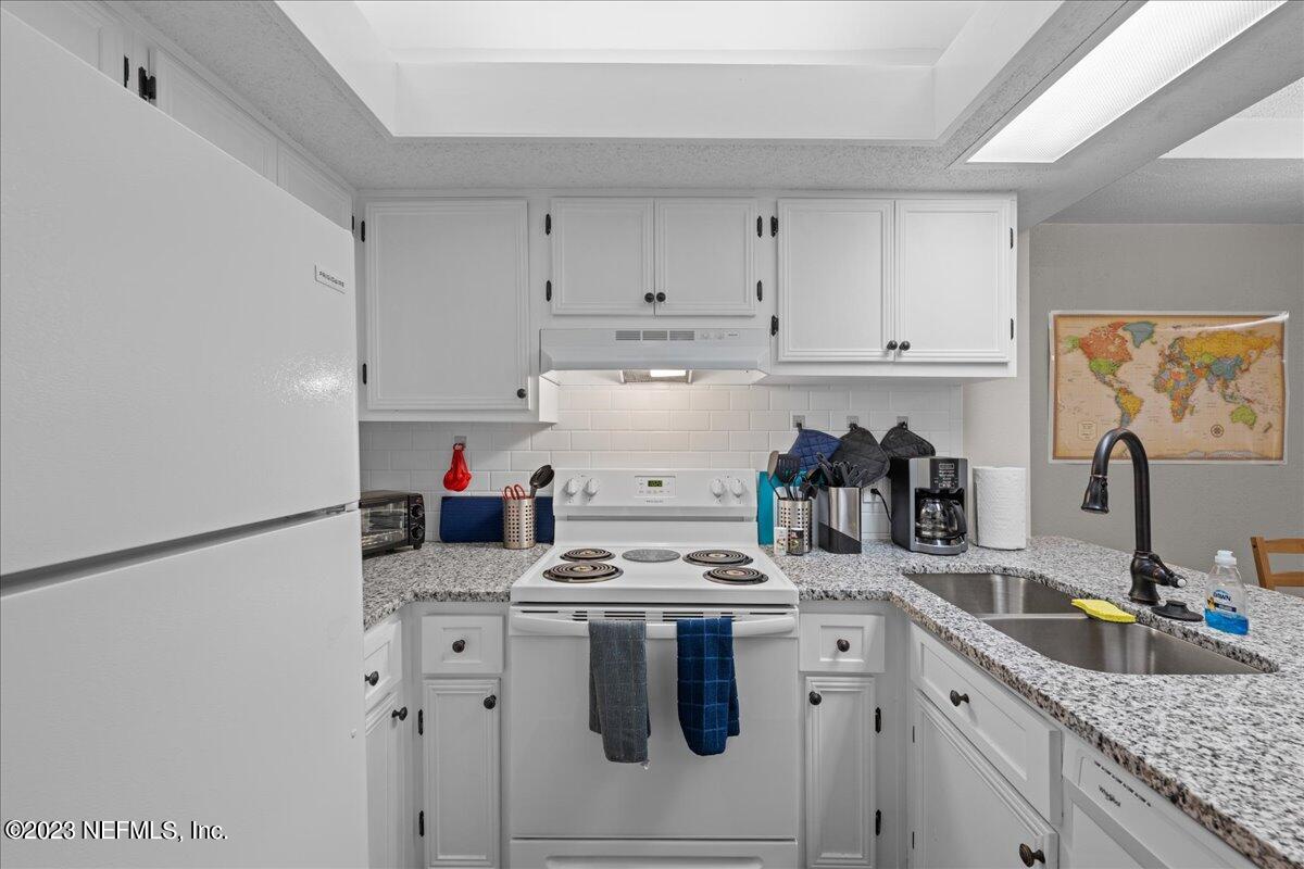 3155 Ravines Road, Unit 3522 Middleburg, FL 32068 - Photo 8 of 20 a kitchen with white cabinets and white appliances