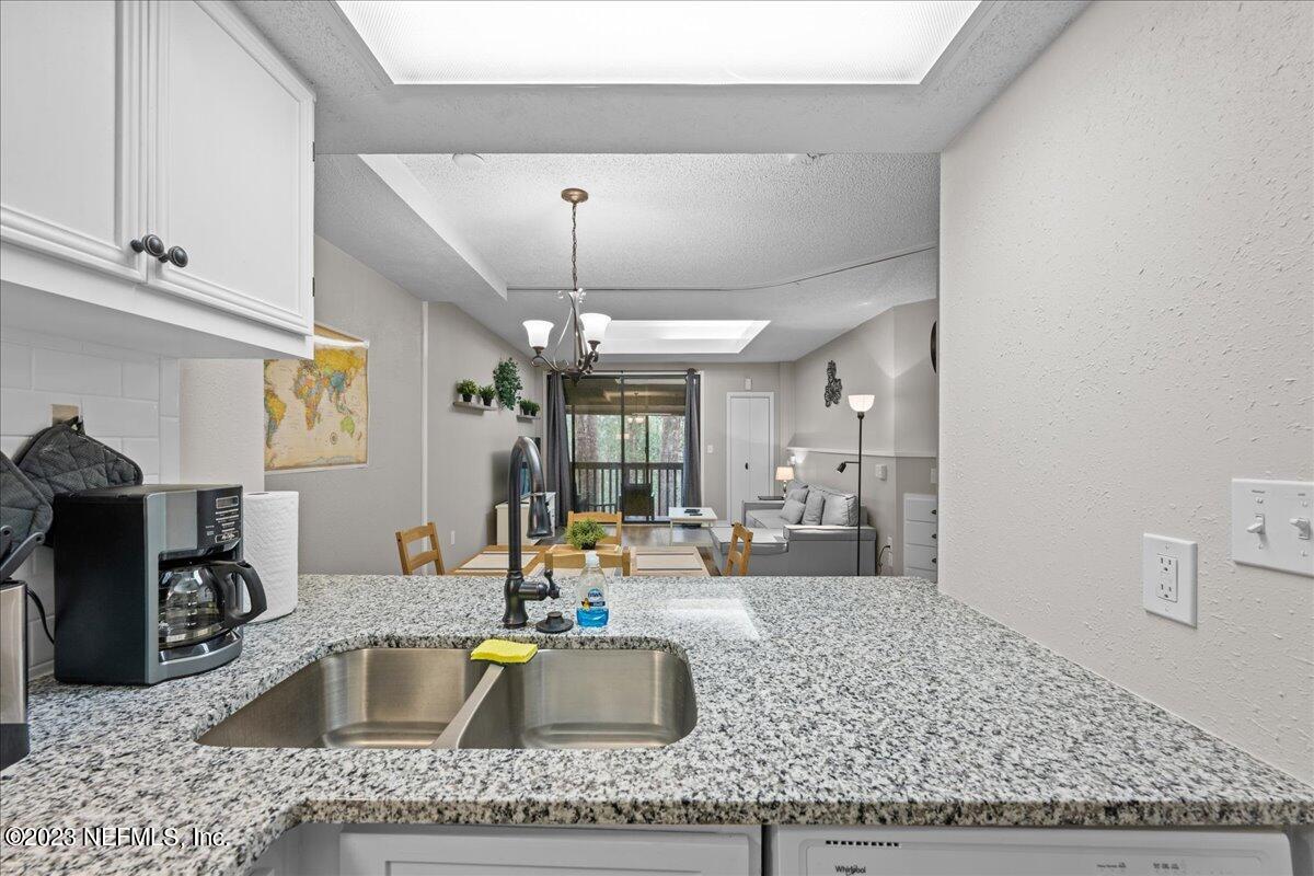 3155 Ravines Road, Unit 3522 Middleburg, FL 32068 - Photo 9 of 20 a kitchen with a stove a counter space and cabinets