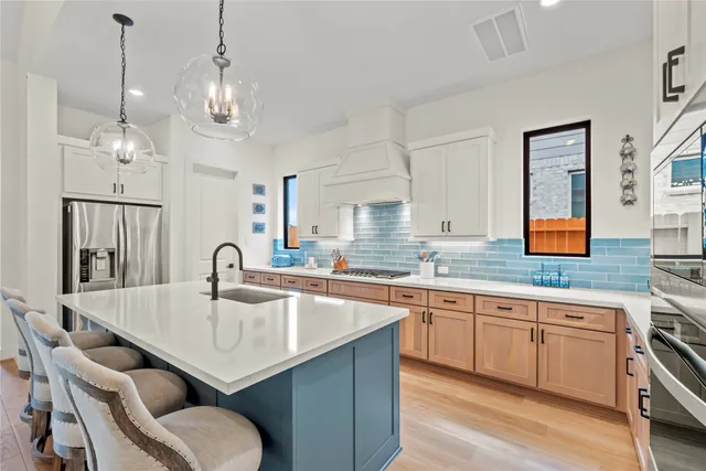 a kitchen with granite countertop a center island and stainless steel appliances