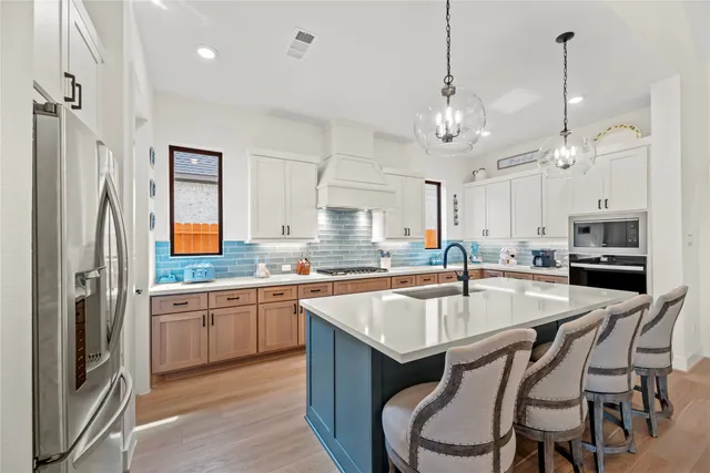a kitchen with a sink stove a microwave and cabinets