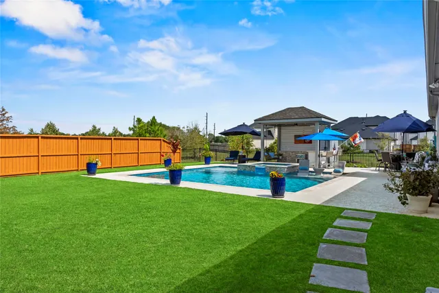 swimming pool view with a seating space