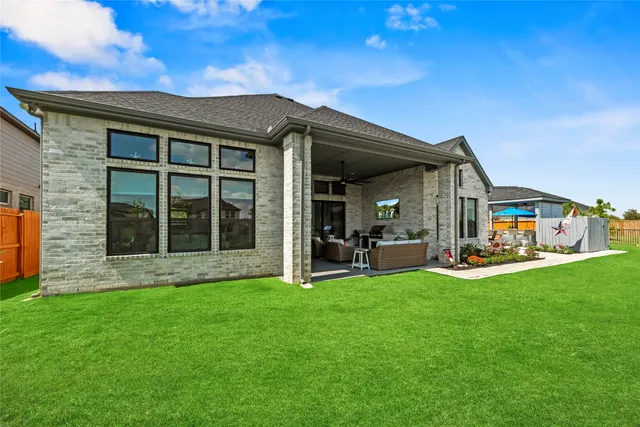a living room with patio furniture and a flat screen tv