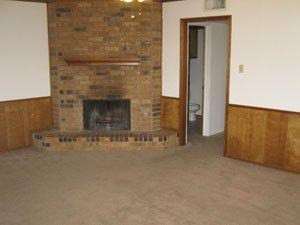 6111 38th Street, Unit A Lubbock, TX 79407 - Photo 2 of 9 a view of empty room with fireplace