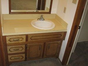 6111 38th Street, Unit A Lubbock, TX 79407 - Photo 6 of 9 a bathroom with a sink and a mirror