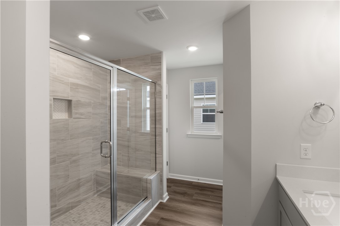 29 Blues Drive Pooler, GA 31322 - Photo 32 of 40 Primary bathroom features double vanities w/ a quartz top, framed mirror, and a large 6' tiled shower-only with a bench! Private water closet.