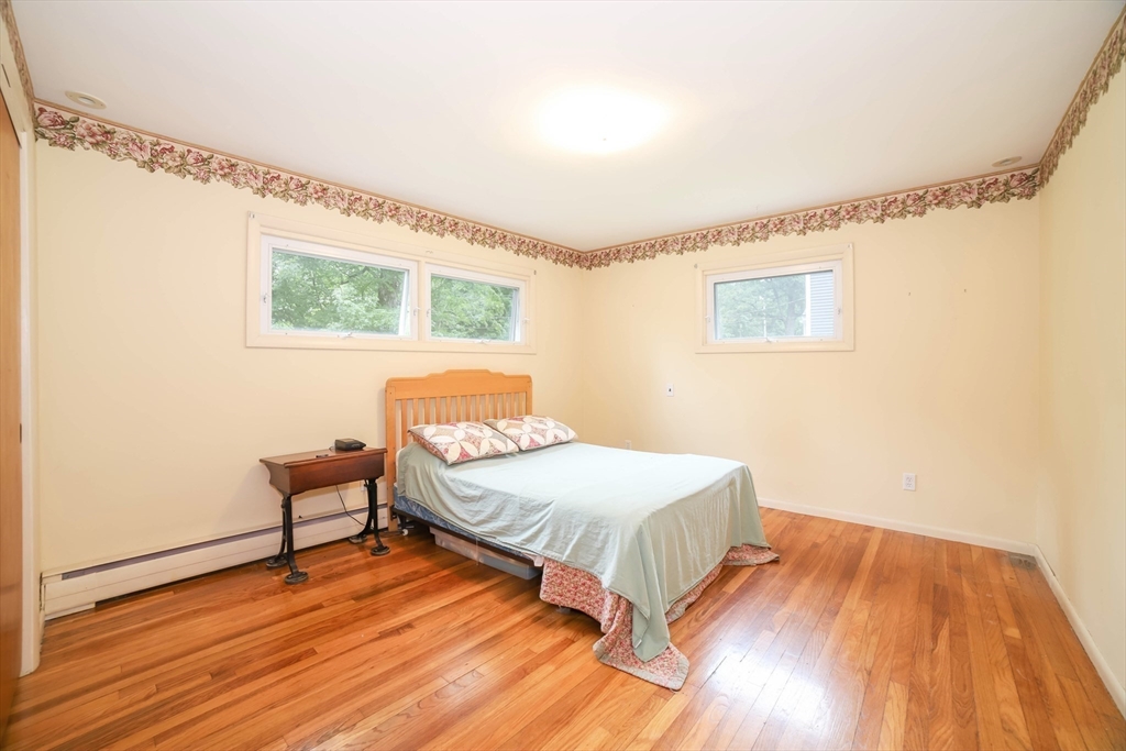 6 Reservoir Street Cherry Valley, MA 01611 - Photo 14 of 35 a bedroom with a bed and a table