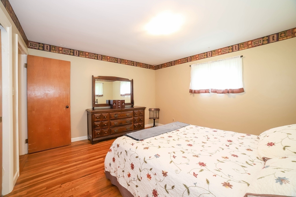 6 Reservoir Street Cherry Valley, MA 01611 - Photo 19 of 35 a bedroom with a bed and wooden floor