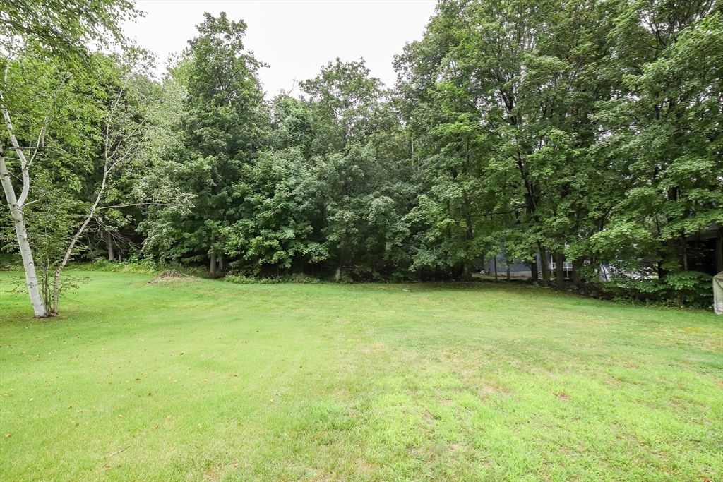 6 Reservoir Street Cherry Valley, MA 01611 - Photo 32 of 35 a view of a big yard with a trees