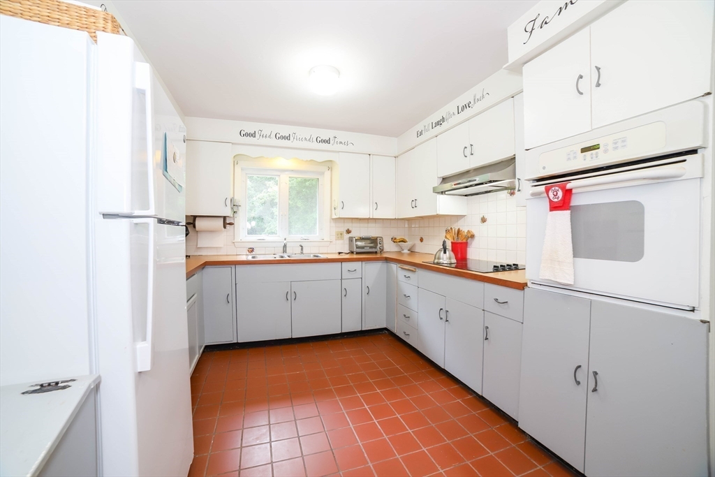 6 Reservoir Street Cherry Valley, MA 01611 - Photo 8 of 35 a kitchen with white cabinets and white appliances