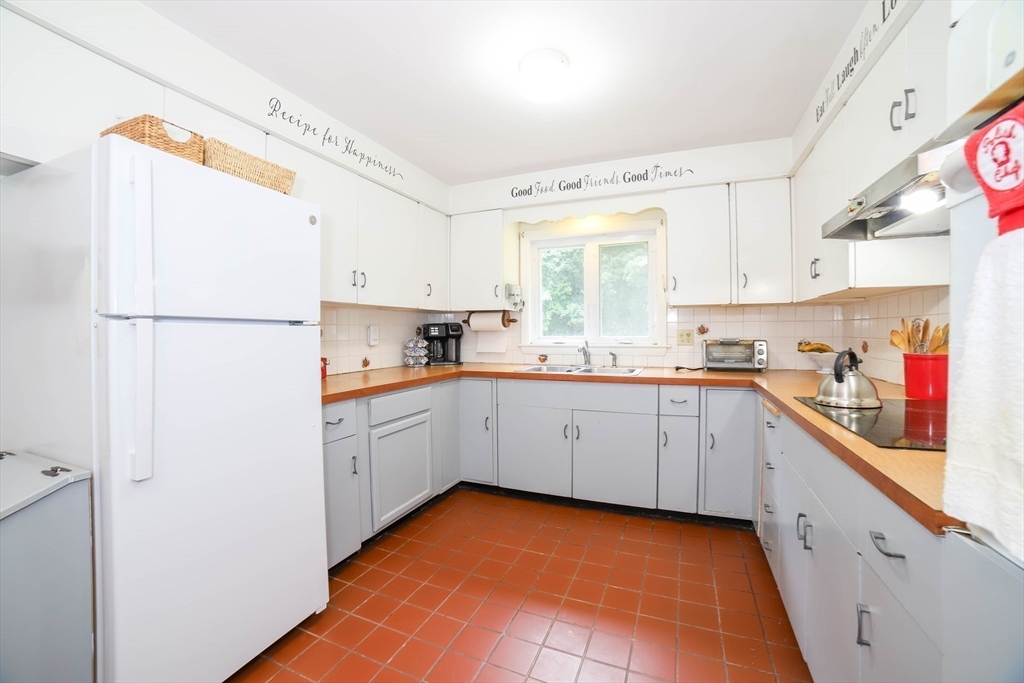 6 Reservoir Street Cherry Valley, MA 01611 - Photo 9 of 35 a kitchen with a sink a refrigerator and window