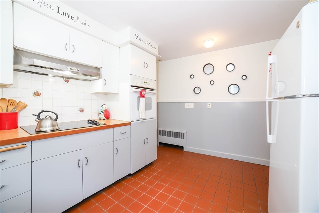 6 Reservoir Street Cherry Valley, MA 01611 - Photo 10 of 35 a kitchen with cabinets and white appliances