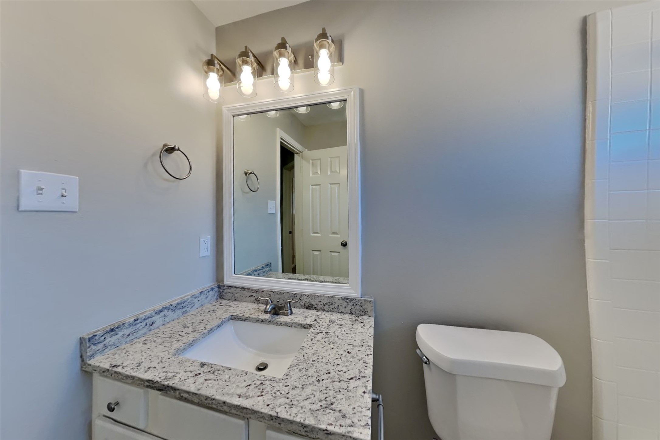 21122 Covington Bridge Lane Spring, TX 77388 - Photo 18 of 26 a bathroom with a granite countertop sink a toilet and a mirror