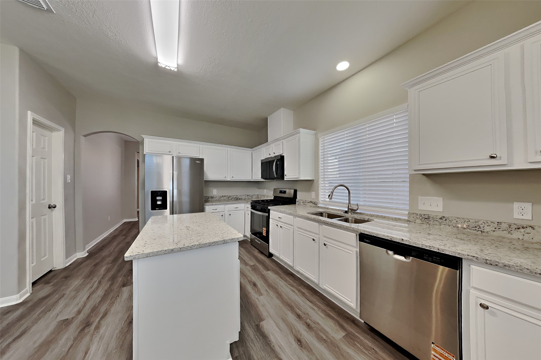 21122 Covington Bridge Lane Spring, TX 77388 - Photo 6 of 26 a kitchen with stainless steel appliances granite countertop a sink stove and refrigerator