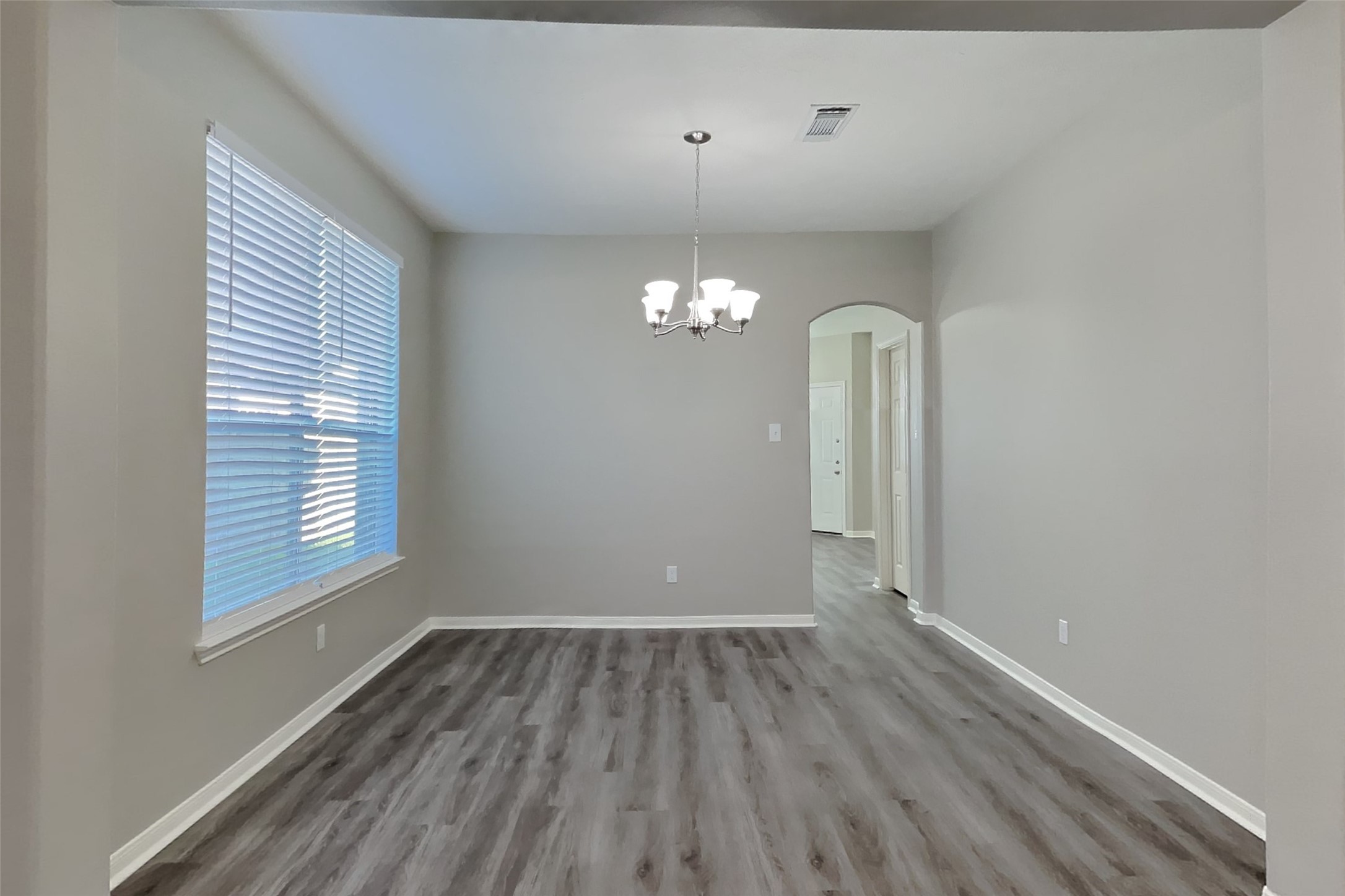 21122 Covington Bridge Lane Spring, TX 77388 - Photo 9 of 26 wooden floor in an empty room with a window