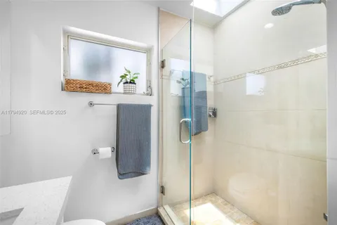 a bathroom with a shower and a sink