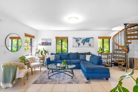 a living room with fireplace furniture and a window