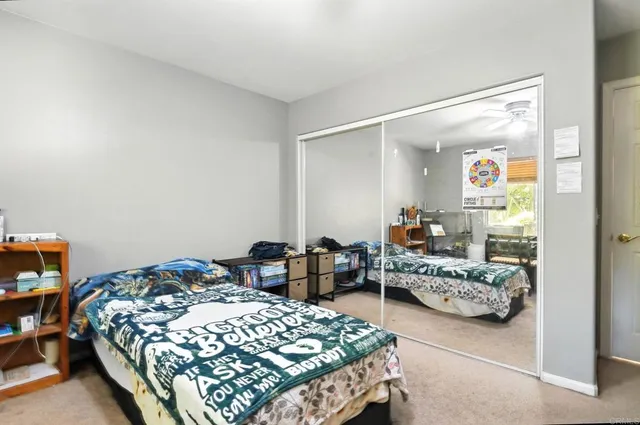 a bedroom with a bed and a table