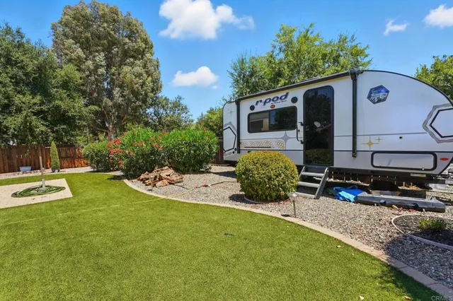 a view of a backyard with plants and patio