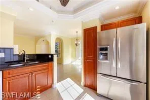 a kitchen with stainless steel appliances granite countertop a refrigerator and a sink