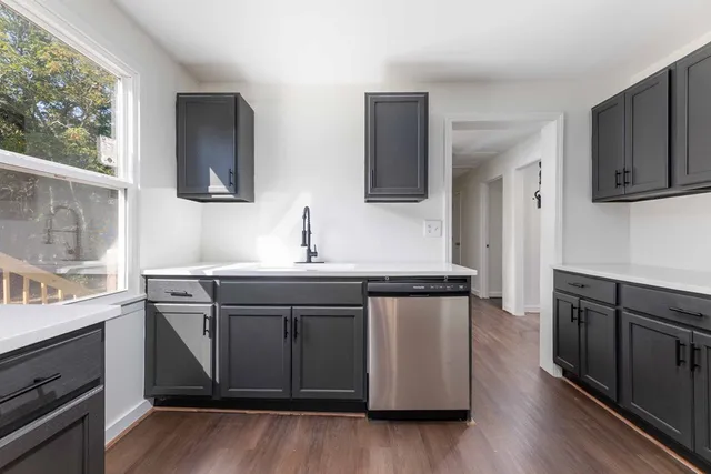 a kitchen with stainless steel appliances granite countertop a sink and stove top oven