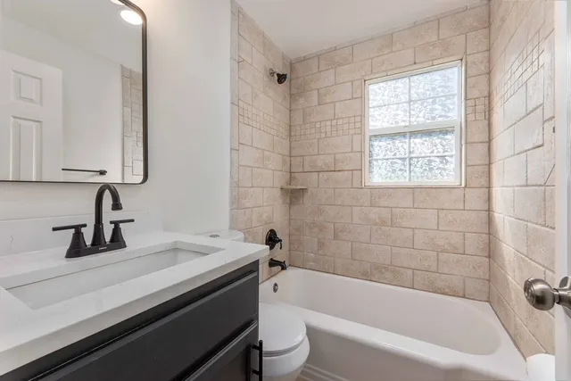 a bathroom with a sink a toilet and a bathtub