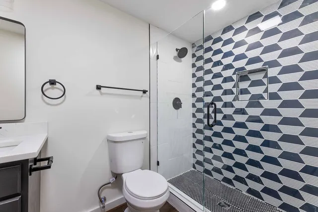 a bathroom with a toilet and a shower