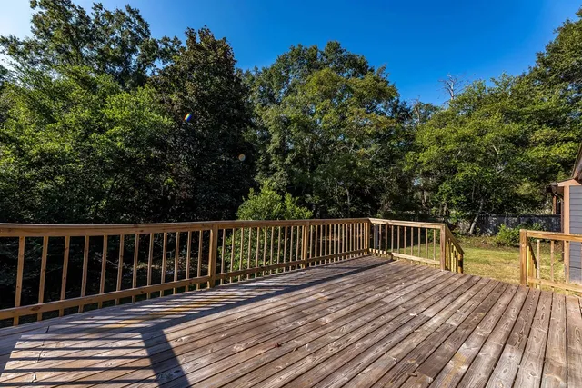 a view of balcony with wooden floor and fence