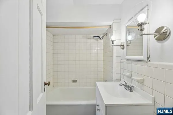 a bathroom with a bathtub and shower