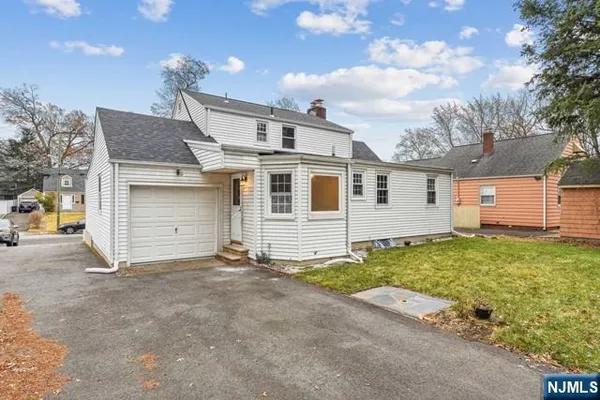 a view of a house with a yard and garage