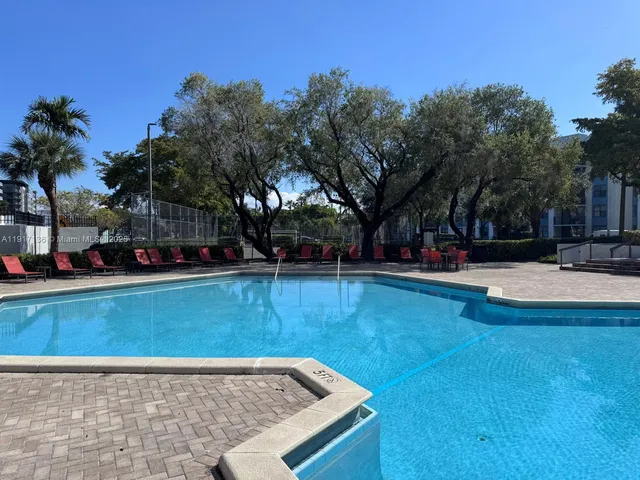 a view of a swimming pool with a bench