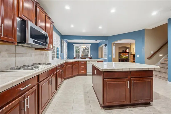 a kitchen with stainless steel appliances granite countertop a stove and a sink