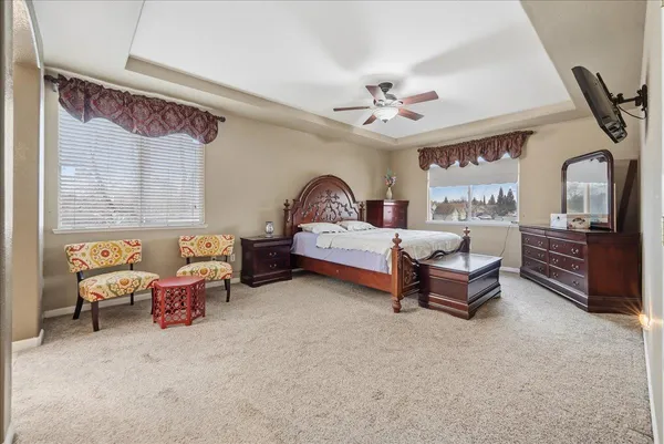 a bedroom with furniture and a large window