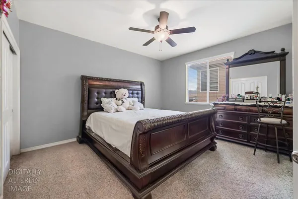 a spacious bedroom with a bed and a chandelier