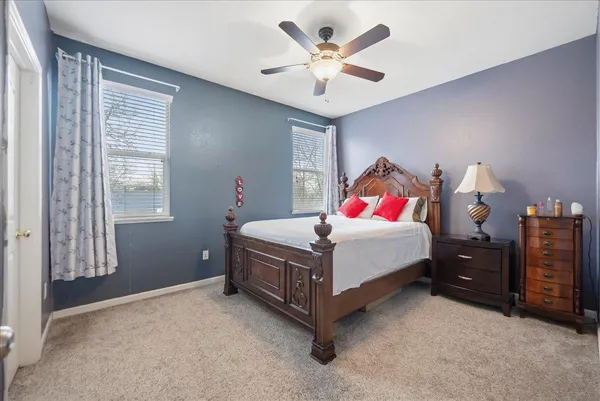 a bed room with a bed and a chandelier