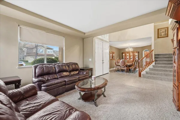 a living room with furniture a table and a large window