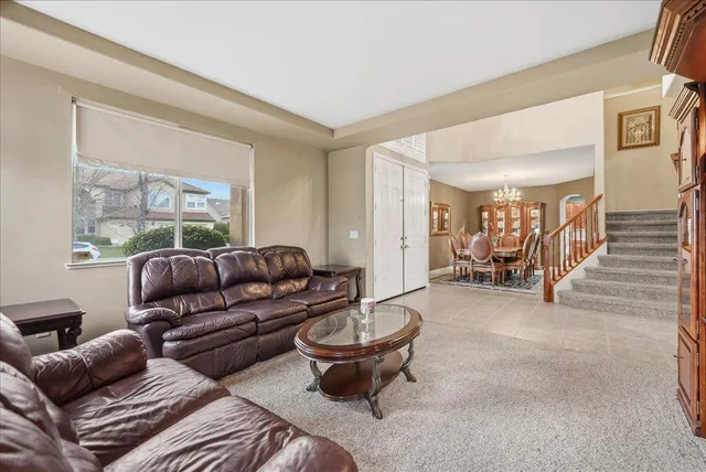 a living room with furniture a table and a large window