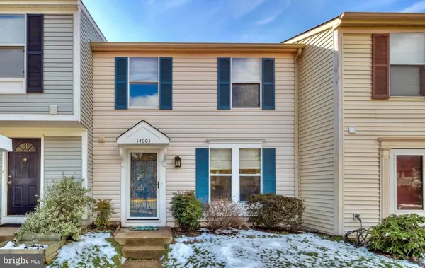 a front view of a house with garden and plants