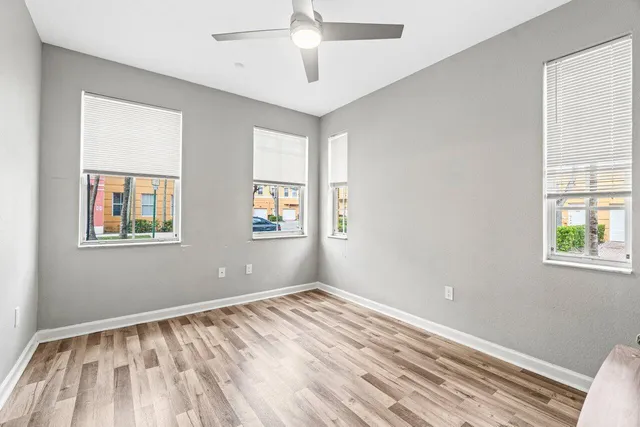 a bathroom with a granite countertop sink toilet and a mirror