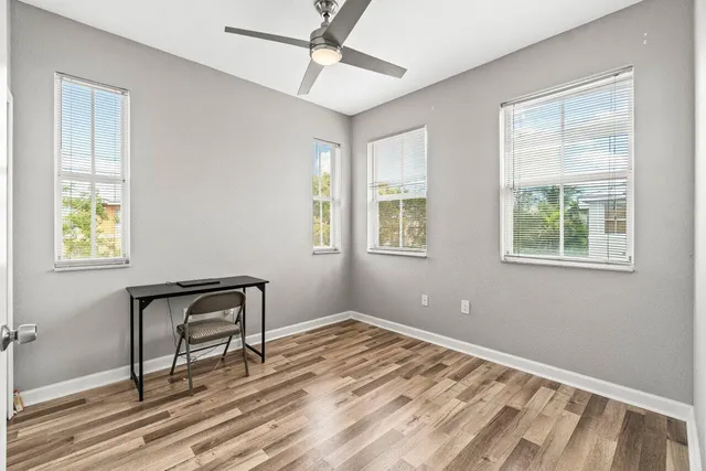 a view of a workspace with furniture and a window