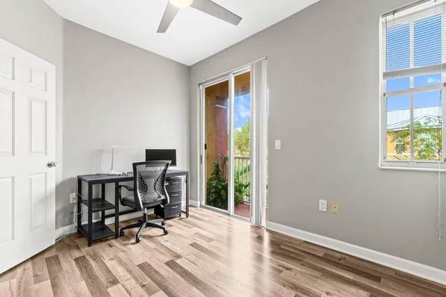 a view of workspace with wooden floor and windows