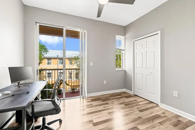 a bedroom that has a bed and a table in it with window