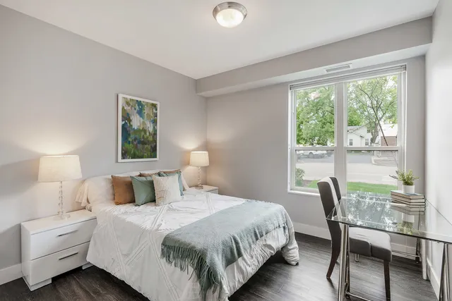 a bedroom with a bed and a large window