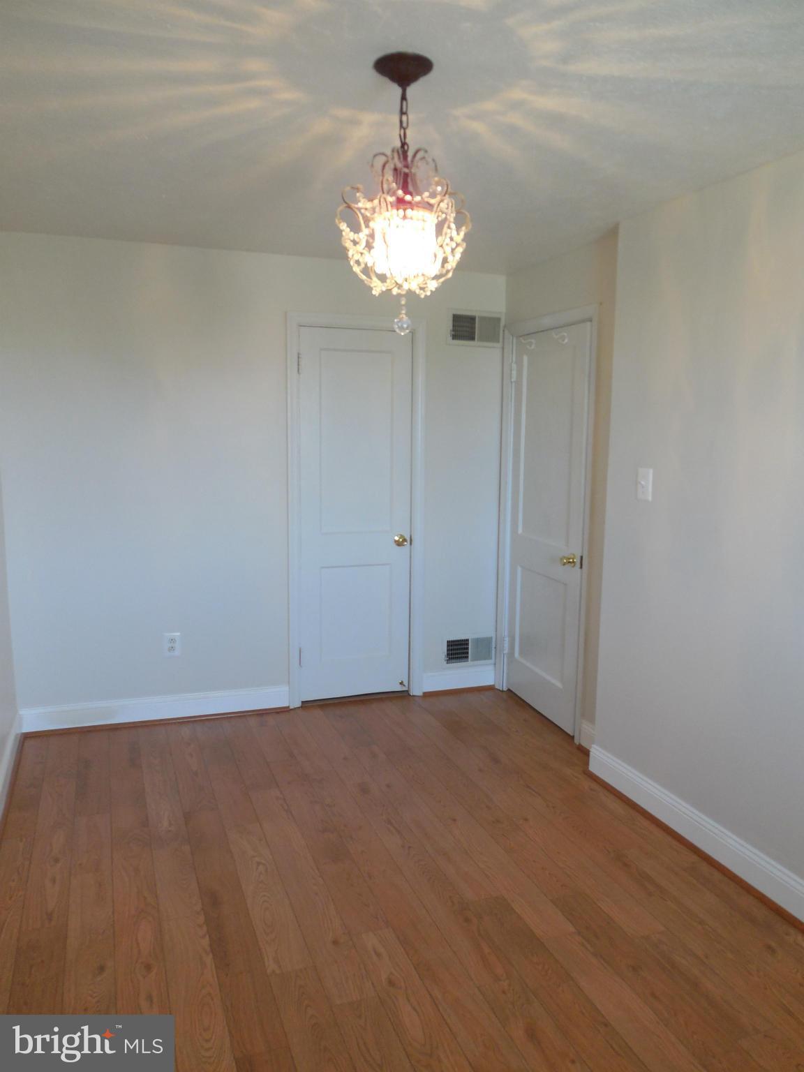 446 Grovethorn Road Baltimore, MD 21220 - Photo 13 of 25 a view of an empty room with a chandelier fan
