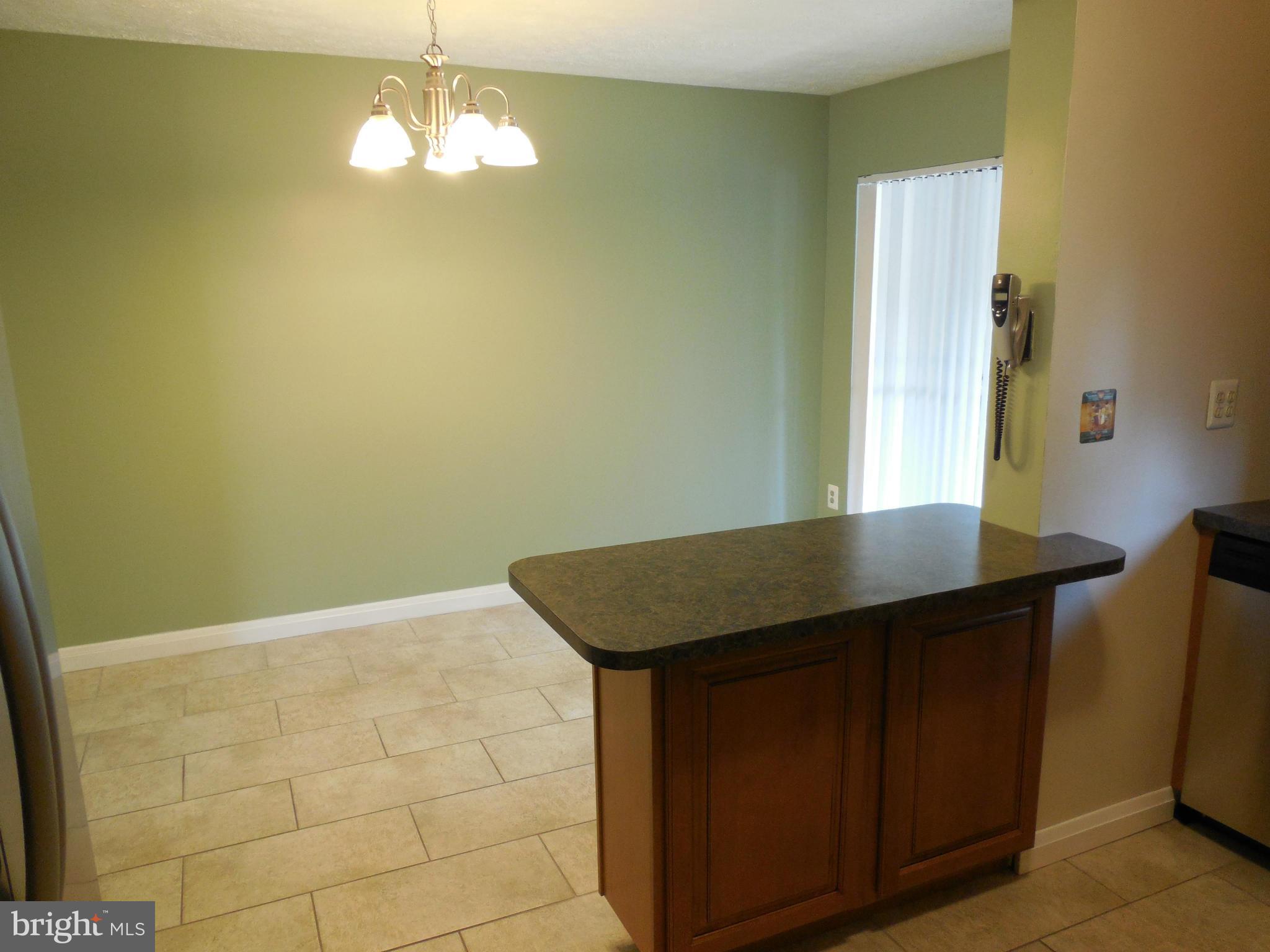 446 Grovethorn Road Baltimore, MD 21220 - Photo 4 of 25 a view of a room with a chandelier fan and wooden floor