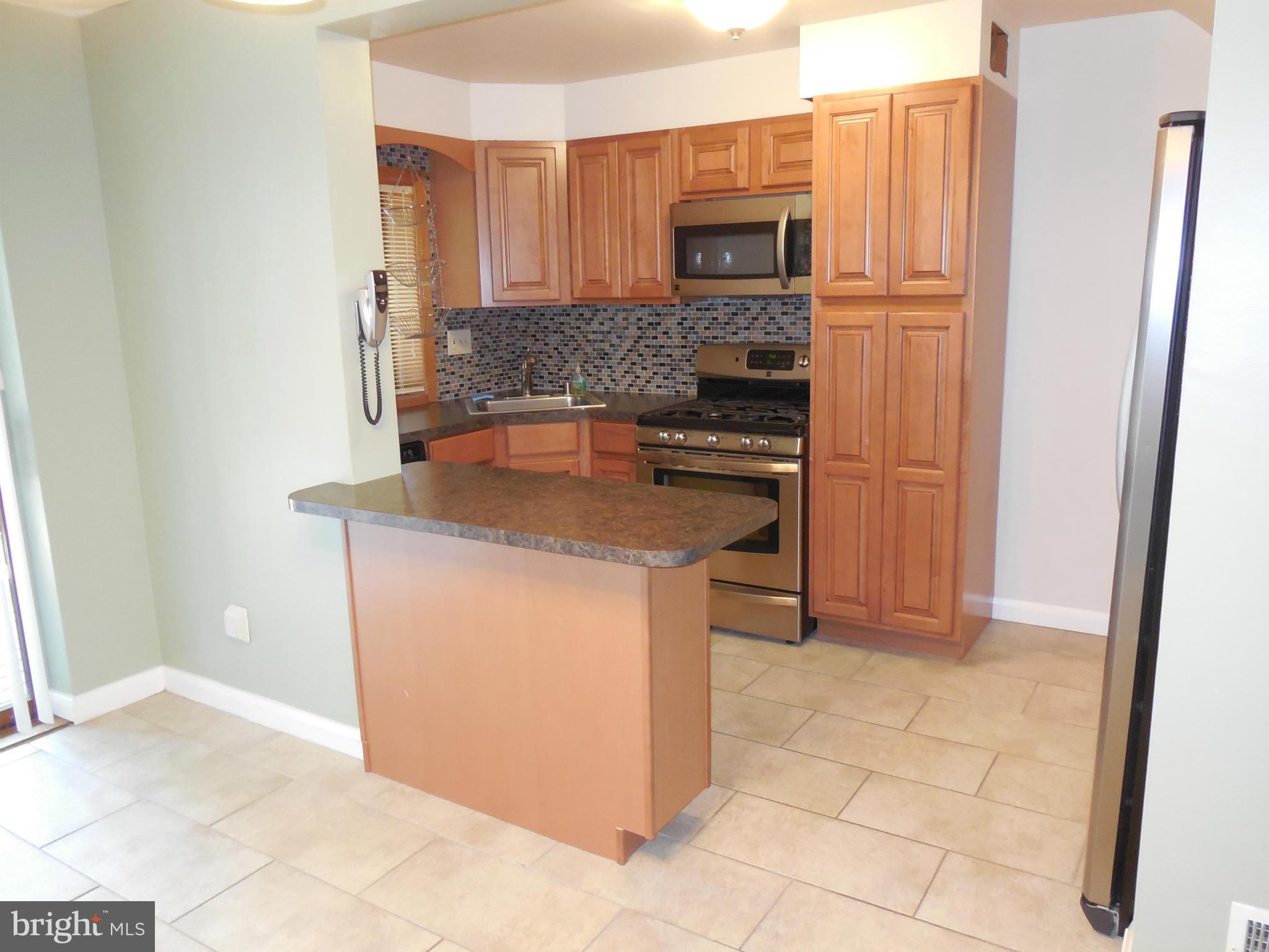 446 Grovethorn Road Baltimore, MD 21220 - Photo 6 of 25 a kitchen with stainless steel appliances granite countertop a refrigerator stove and sink