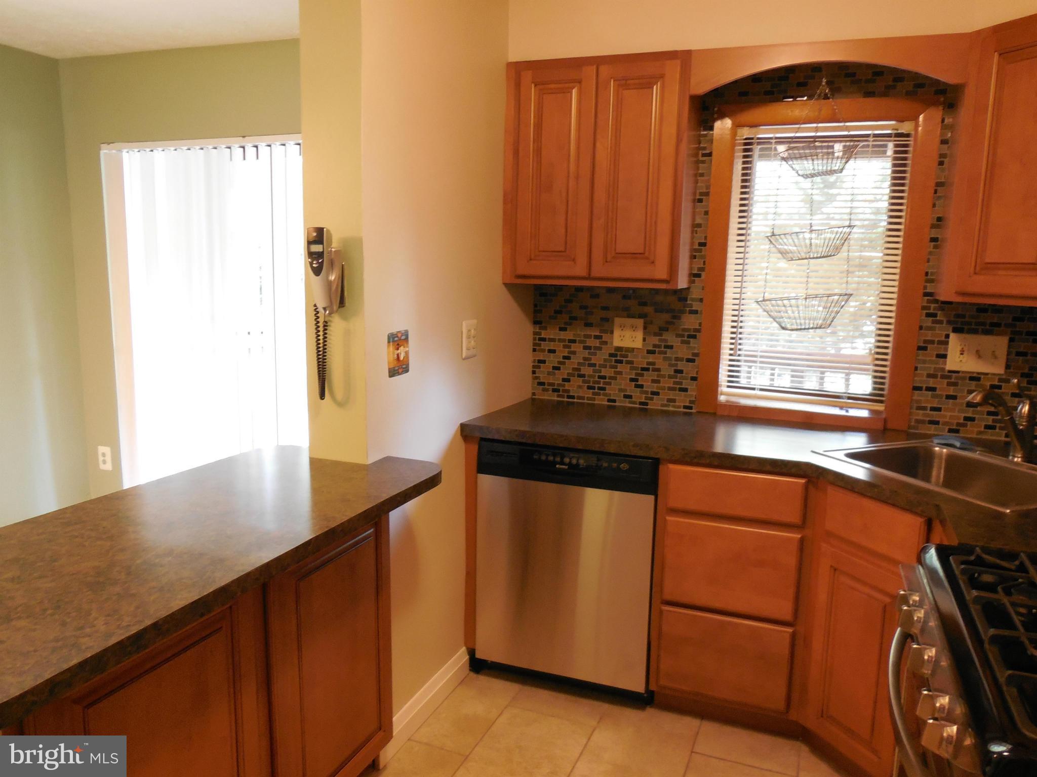446 Grovethorn Road Baltimore, MD 21220 - Photo 8 of 25 a kitchen with stainless steel appliances granite countertop a sink stove and cabinets