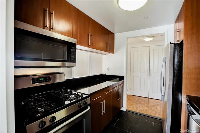 a kitchen with stainless steel appliances a stove and a microwave